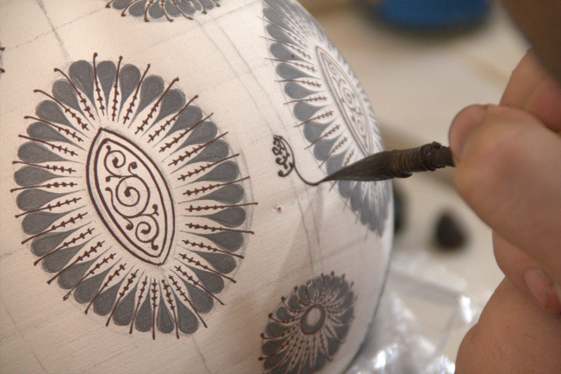 Close-up of intricate hand-painted designs on Uzbek ceramics in Fargʻona, Uzbekistan.