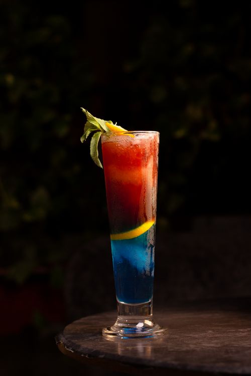 Free Colorful layered cocktail with garnish on table in Kermanshah, Iran. Stock Photo