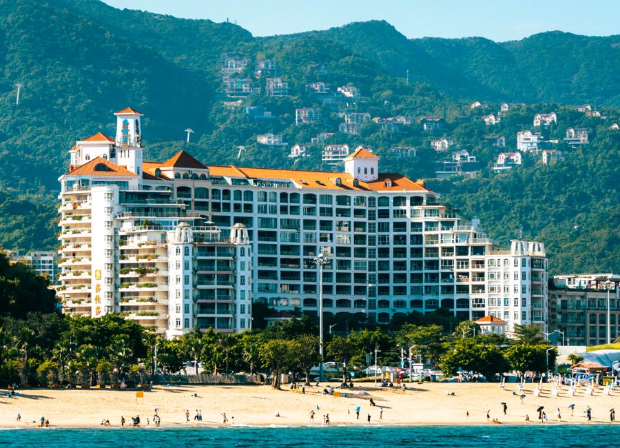 Beautiful beachfront resort with mountain backdrop, capturing coastal luxury and nature.