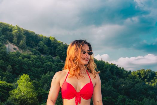 Young woman in red bikini enjoying the summer outdoors at Toronto's picturesque beach.