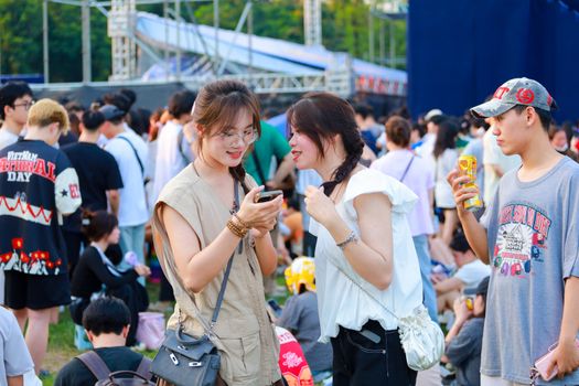 Young adults enjoying a lively outdoor festival in Hà Nội, Việt Nam.