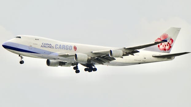 A China Airlines cargo plane captured mid-flight against a clear sky.