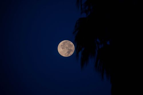 Free Stunning full moon against a dark blue night sky in Pyrgos, Greece. Stock Photo