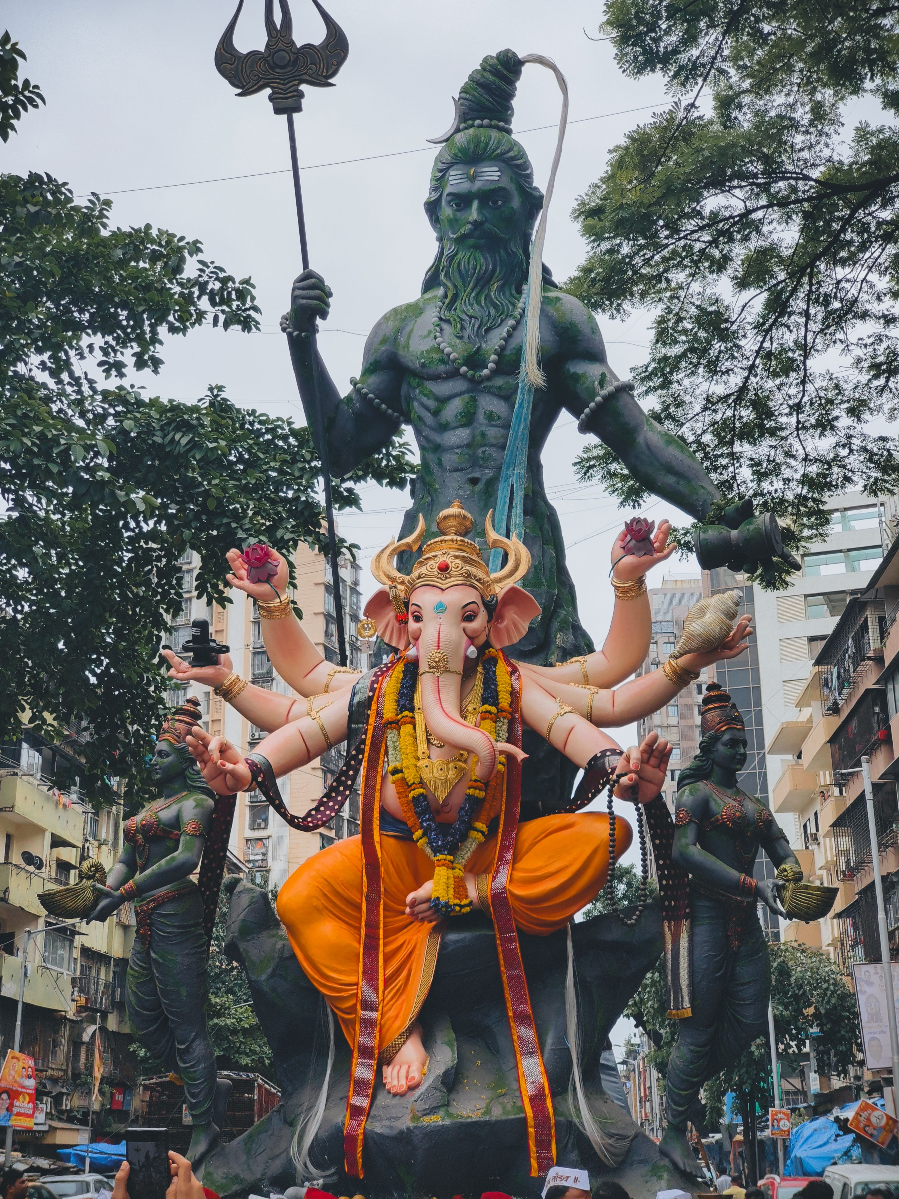 Colorful Ganesh Chaturthi festival featuring a grand Ganesh idol procession in Mumbai streets.