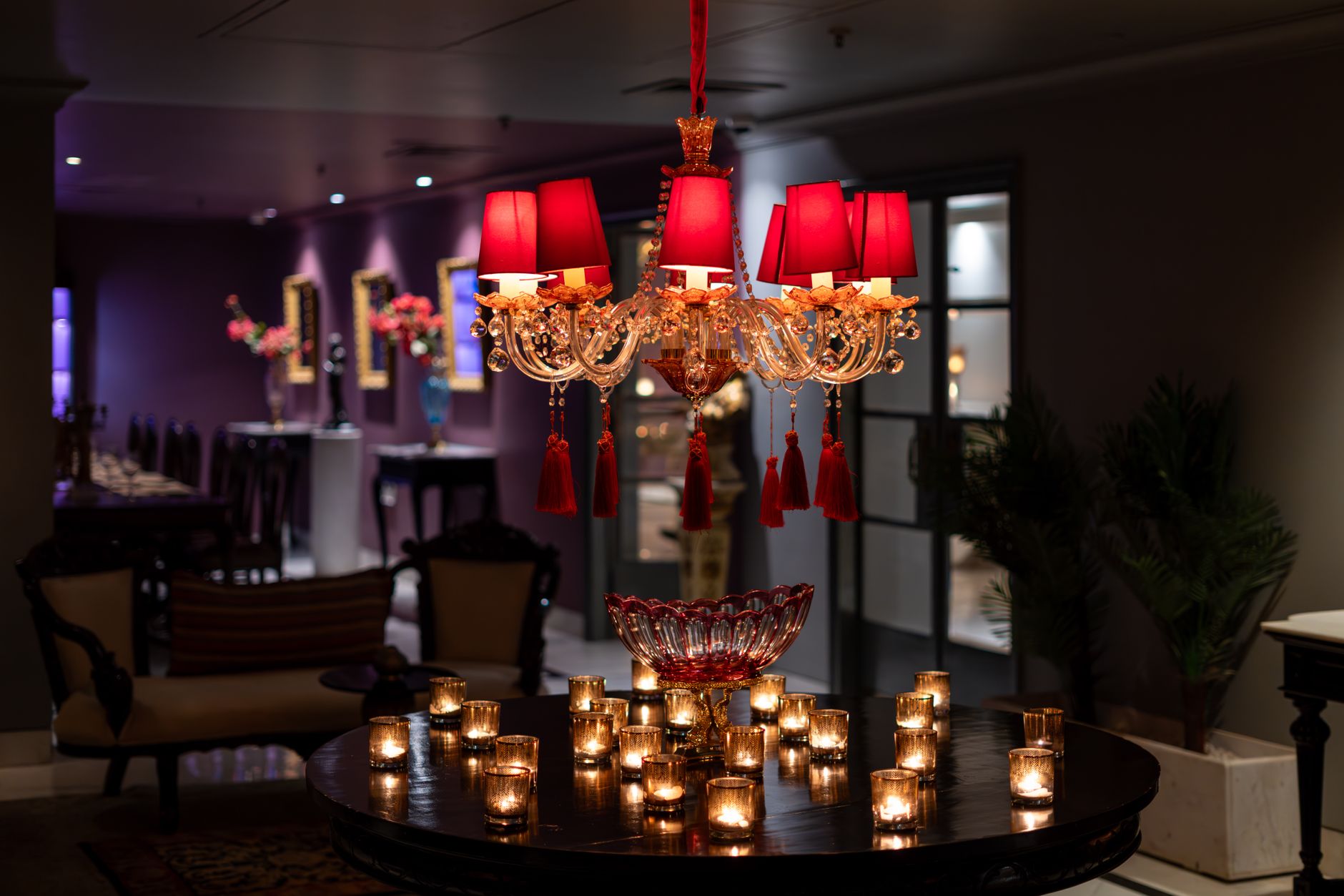Opulent chandelier and warm candlelit ambiance in a luxury Bikaner hotel, Rajasthan, India.
