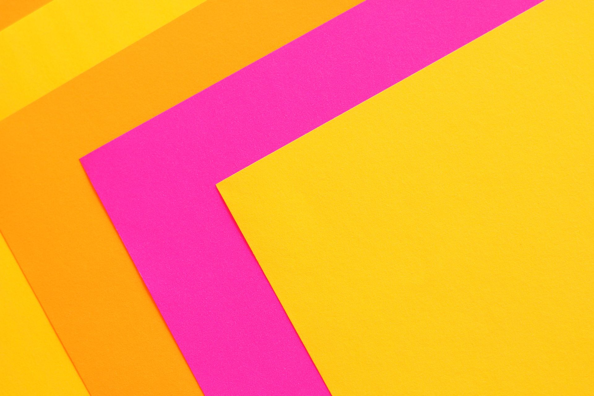 Colorful abstract composition featuring overlapping layers of pink and yellow.