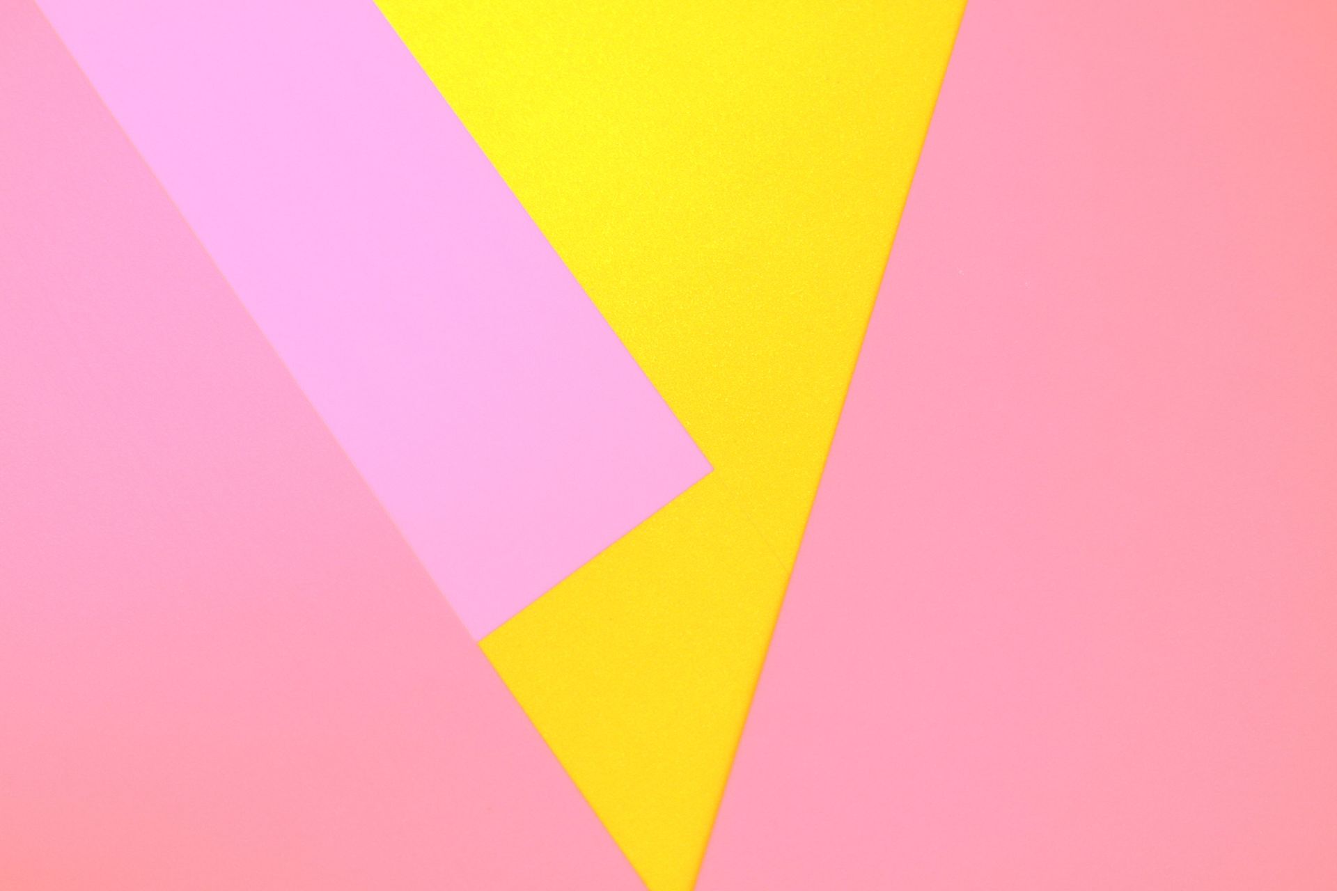 Abstract composition featuring pink and yellow geometric shapes in pastel colors.