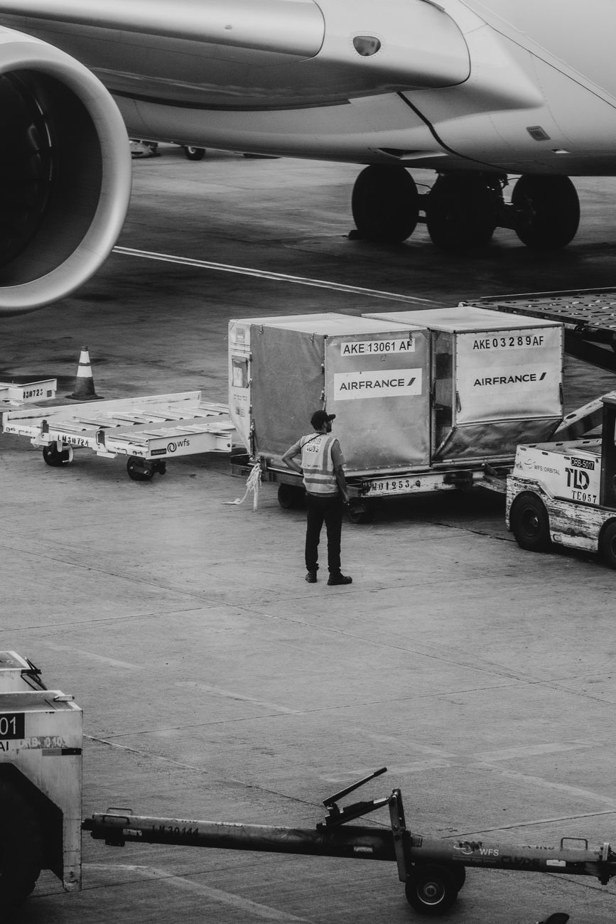 Airport crew managing cargo near an airplane