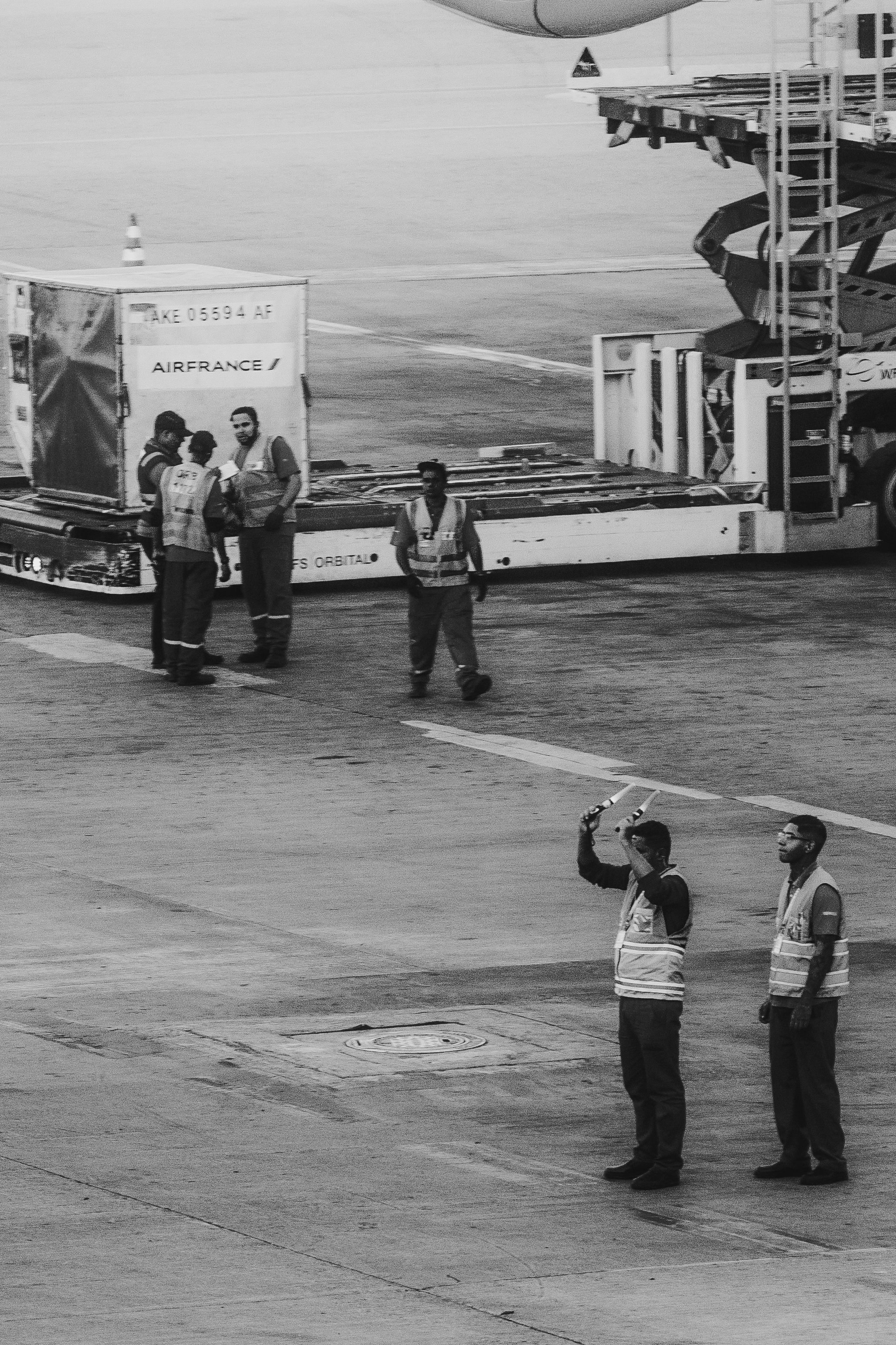 aviation professionals collaborating around a commercial aircraft.