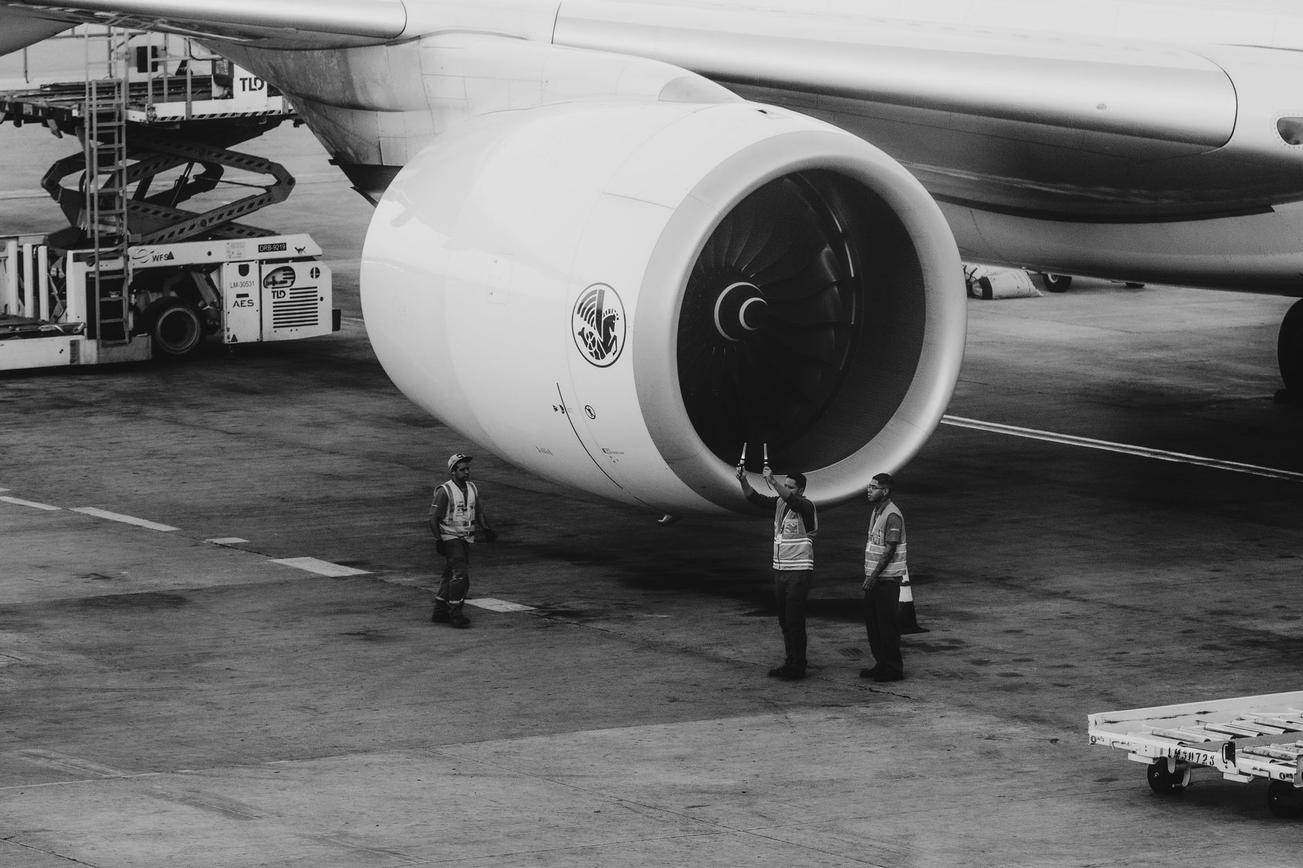 Ground crew inspecting a large commercial jet engine — the scale of engineering employers we want at the table