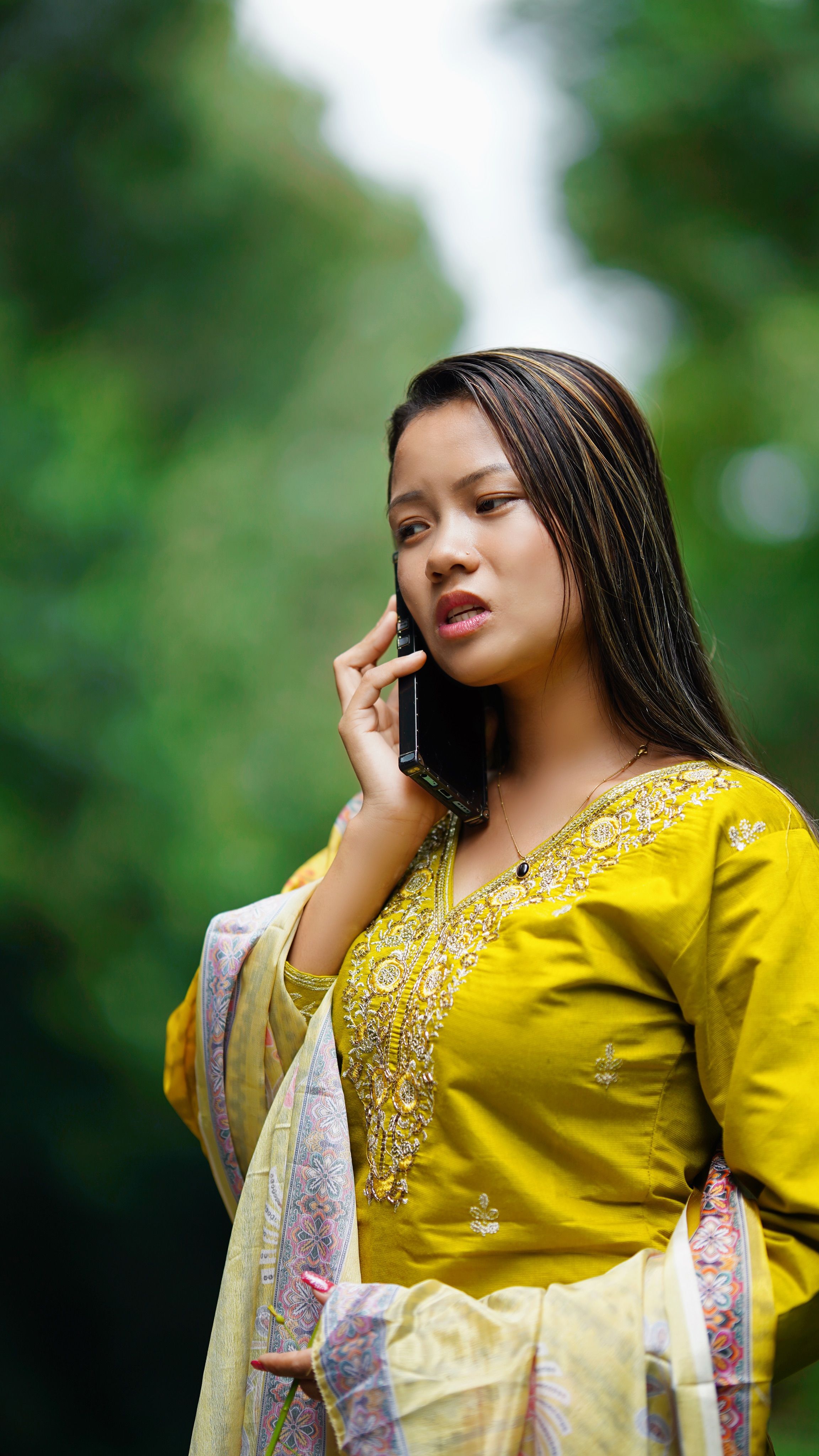 Young Woman in Traditional Dress Talking on Phone · Free Stock Photo