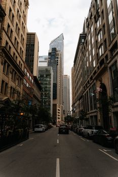 Captivating view of a bustling street in downtown Montreal with towering skyscrapers.