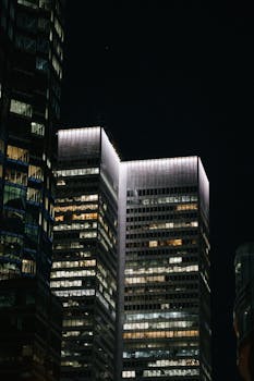 A nighttime cityscape of Montreal showcasing brightly lit modern skyscrapers.