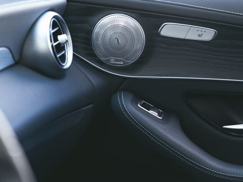 Free Close-up of a luxury car's sleek interior showcasing a premium speaker and air vent design. Stock Photo
