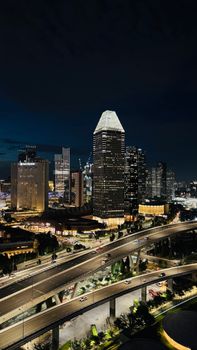 A stunning night view of a city skyline with illuminated skyscrapers and highways.