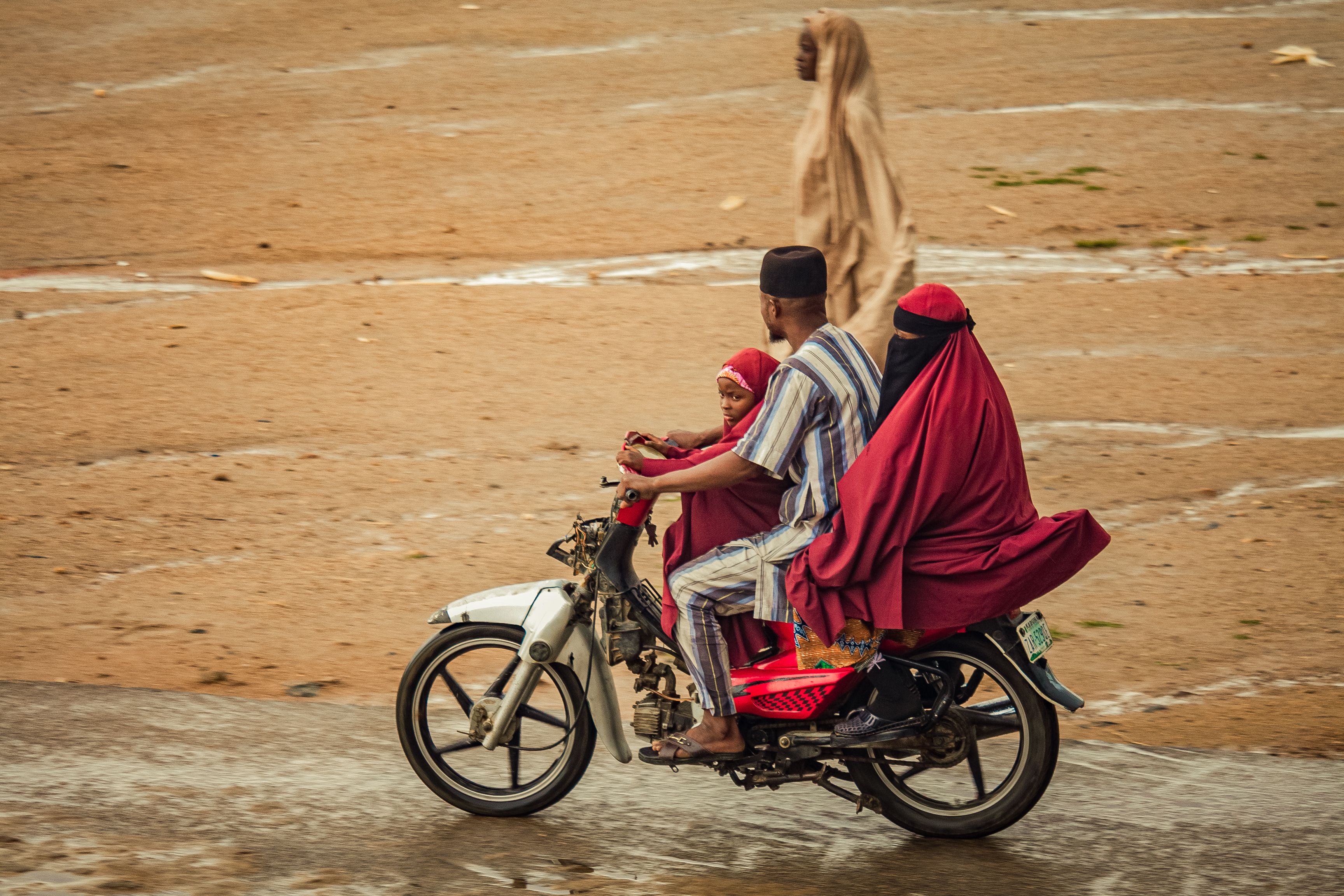 Family Riding Motorcycle on Rural Road · Free Stock Photo