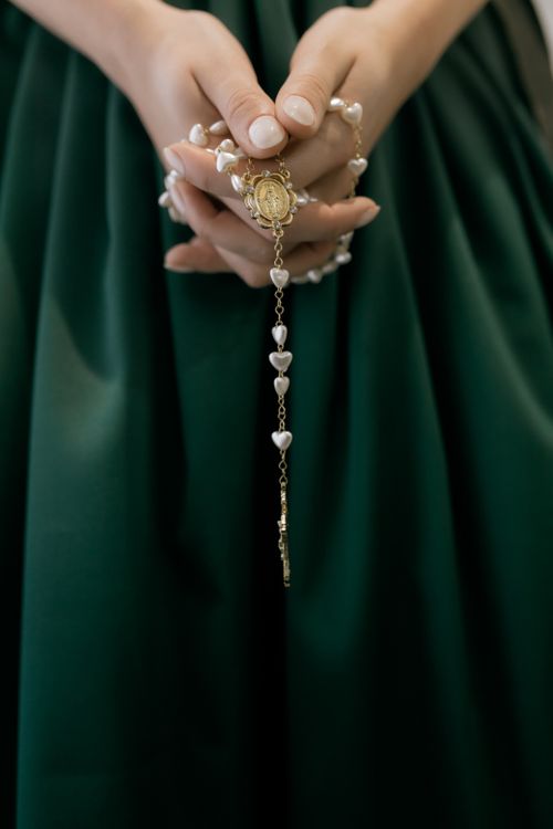 Free A close-up shot of hands holding a rosary, symbolizing faith and spirituality. Stock Photo