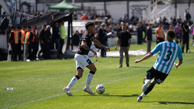 Two soccer players in action during a competitive outdoor match.