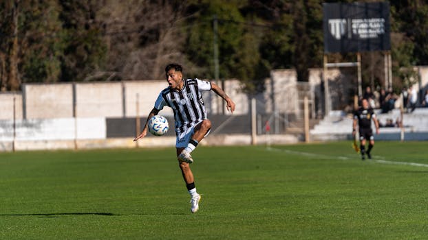 Soccer player skillfully controls the ball during a match, showcasing athletic prowess.