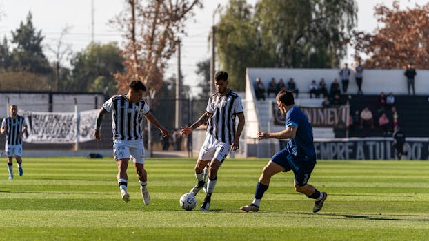 Players in action during an outdoor football match on a sunny day.