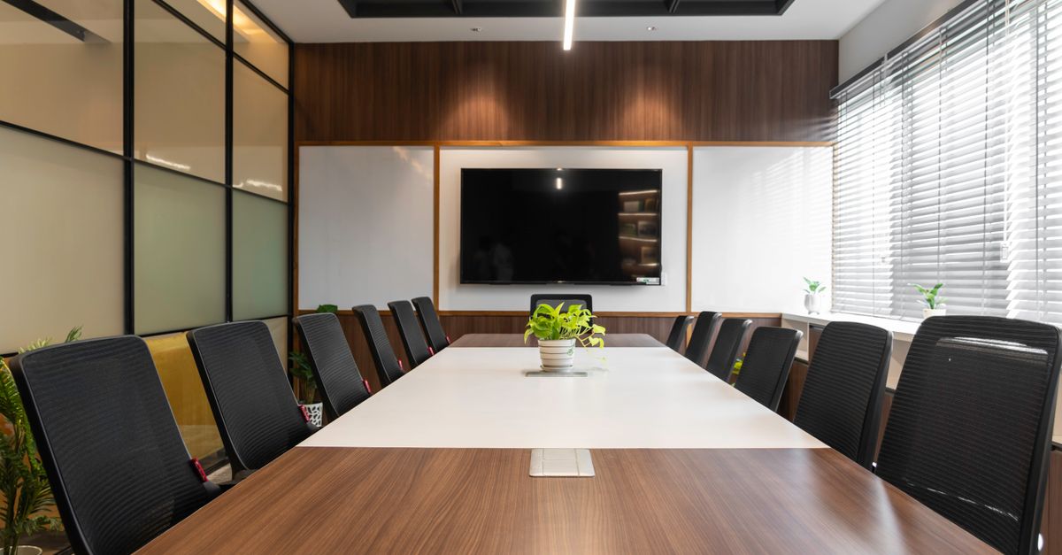 Spacious conference room with a sleek design and contemporary wooden features, ideal for meetings.