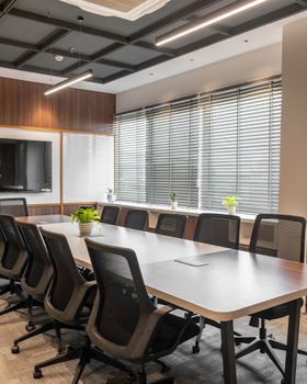 Sleek boardroom with conference table, chairs, and natural lighting in Sahibzada Ajit Singh Nagar.