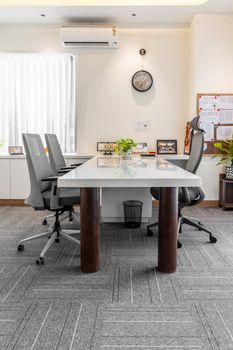 A professional office interior featuring a conference table, chairs, and decor in Sahibzada Ajit Singh Nagar.