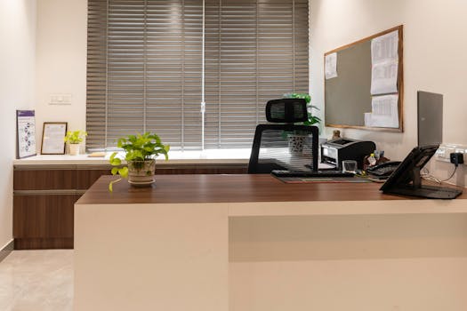 A stylish office setup with a wooden desk, chair, and decor, offering a professional ambiance.