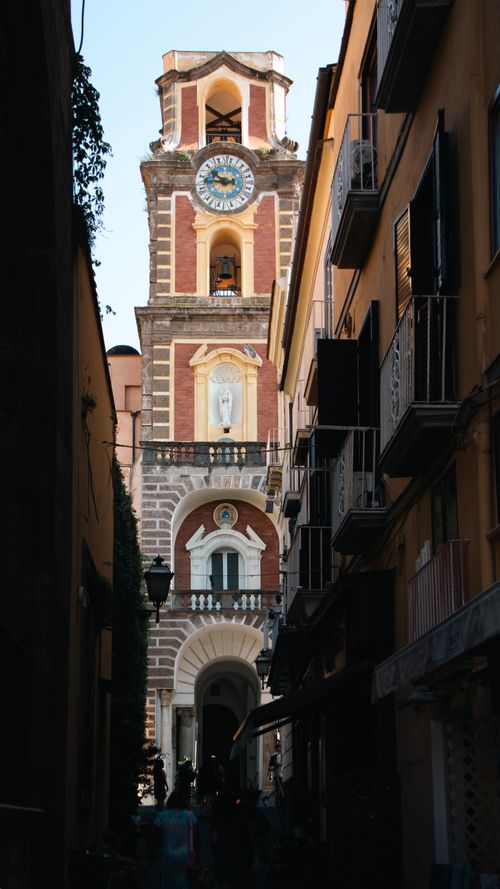 Free Scenic view of Sorrento's iconic clock tower surrounded by narrow alleys. Stock Photo