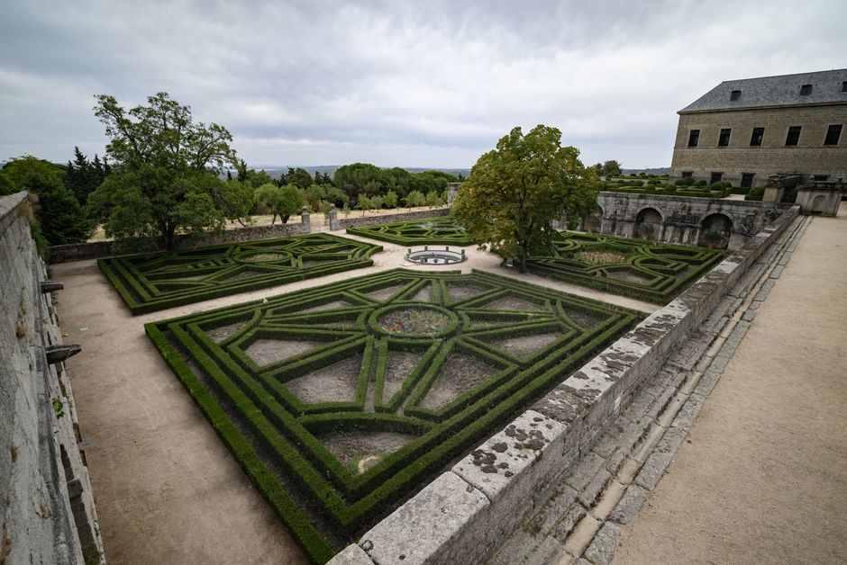 A symmetrical geometric garden with intricate hedges and pathways