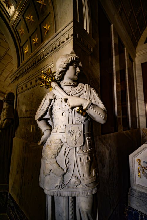 Free Intricately carved marble statue in ornate archway, showcasing regal medieval attire in Madrid. Stock Photo