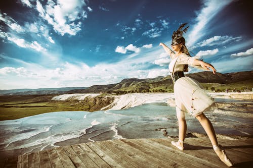 A graceful ballet dancer performs an elegant pose at Pamukkale's stunning travertine terraces.