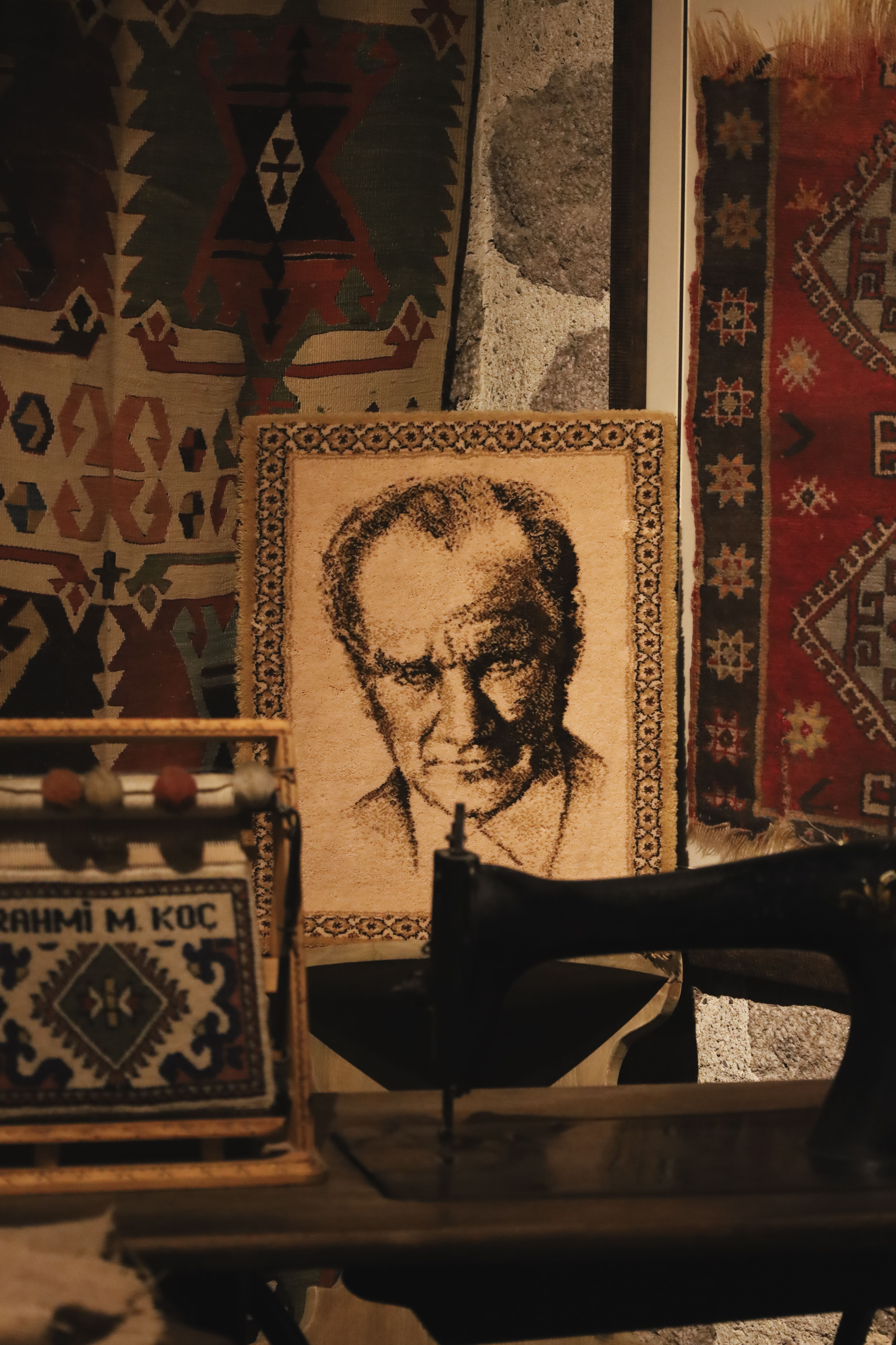 Portrait of Atatürk surrounded by traditional Ankara carpets, evoking Turkish heritage.