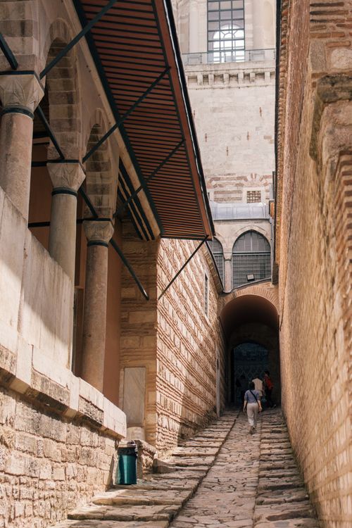 Free A scenic view of a narrow stone pathway leading to Topkapi Palace in Istanbul, showcasing historical architecture. Stock Photo