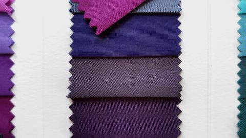 A selection of fabric swatches in different shades of purple, arranged vertically for textile design.