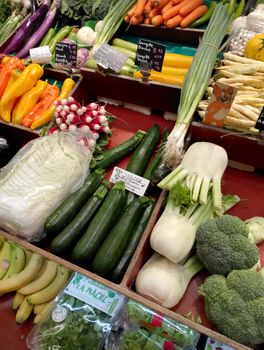 A vibrant display of fresh vegetables at a Paris market stall showcasing diverse produce.