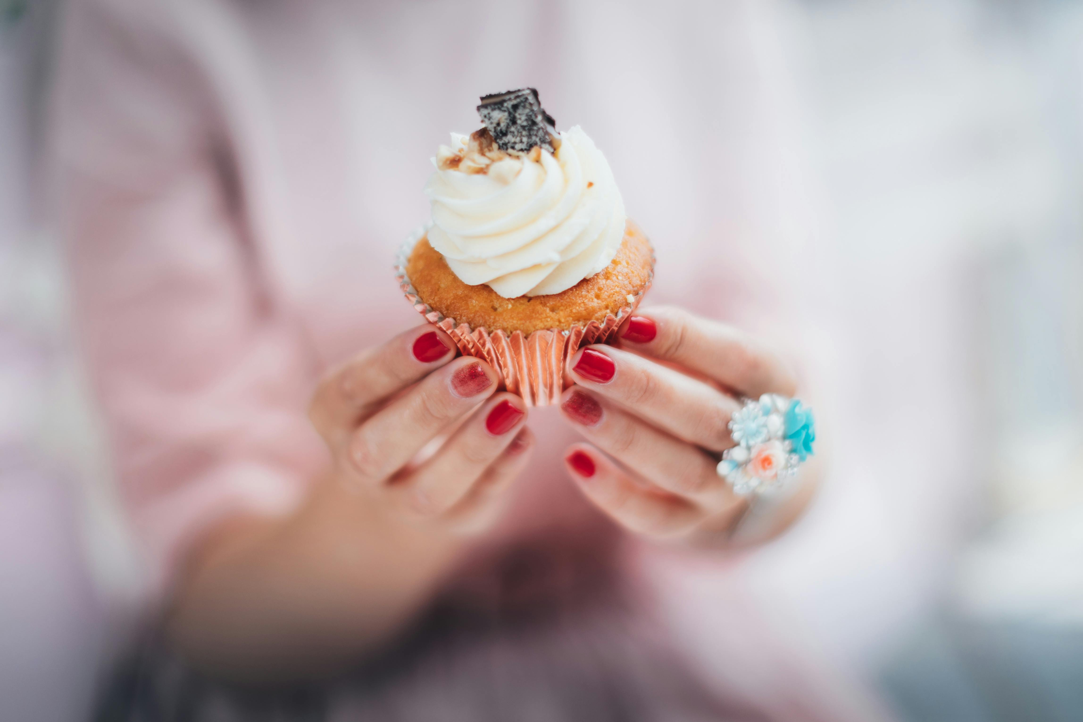 Woman Holding Cupcake with Cream · Free Stock Photo