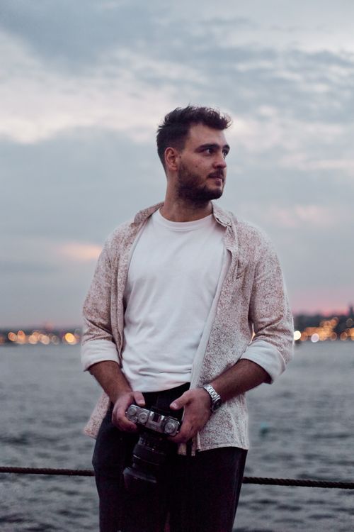 Free Young man with camera at sunset by the Bosphorus in Istanbul. Stock Photo