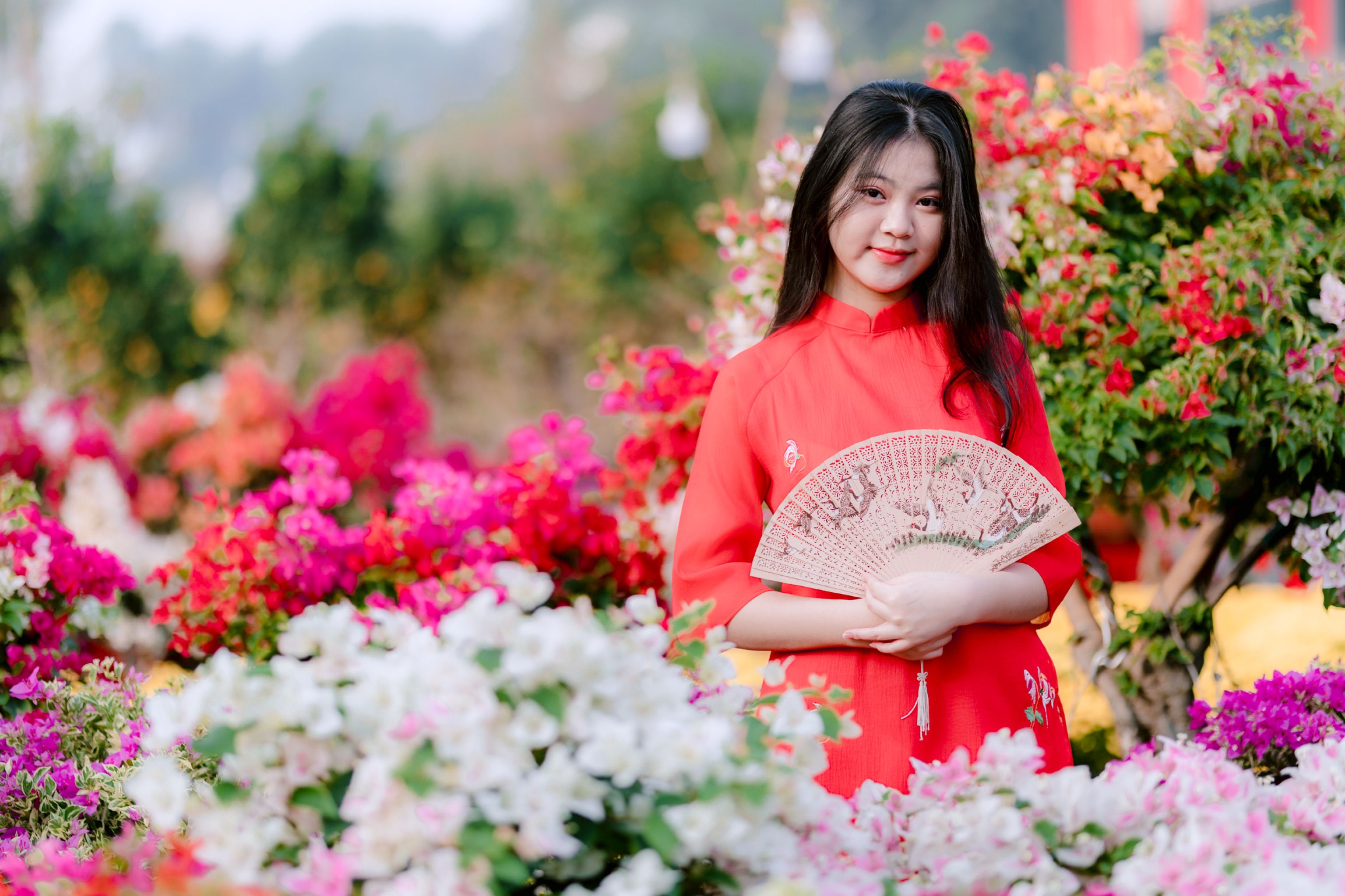 Young Woman in Traditional Dress with Floral Background · Free Stock Photo