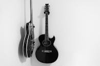 Black and White Acoustic and Electric Guitars on Wall
