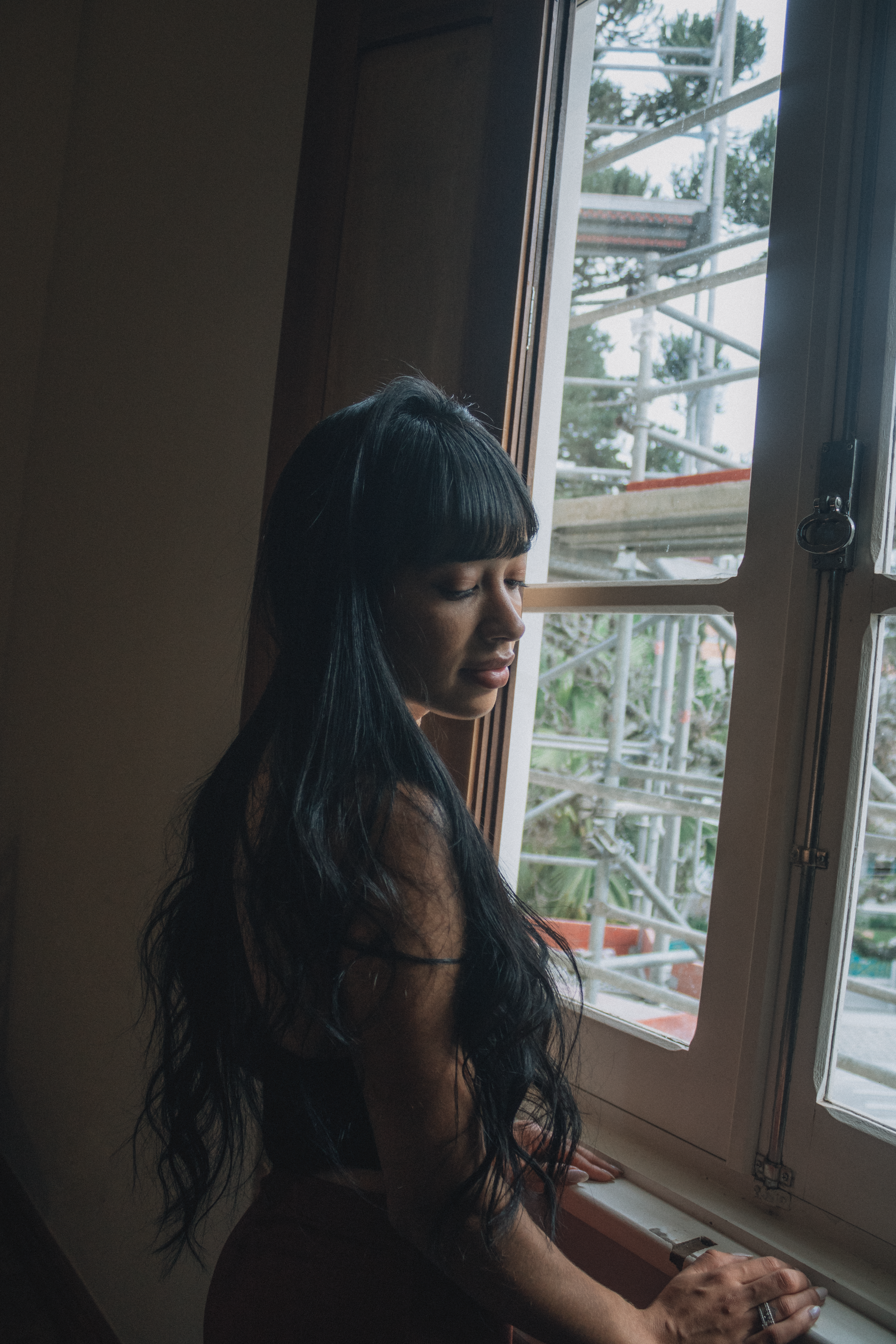Woman Looking Out the Window with Long Black Hair · Free Stock Photo