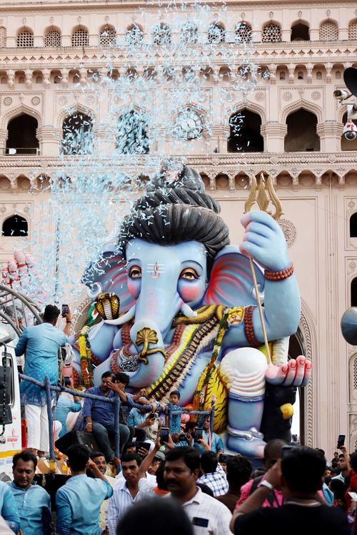 Free Large Ganesha statue adorned with decorations during vibrant cultural festival in India. Stock Photo