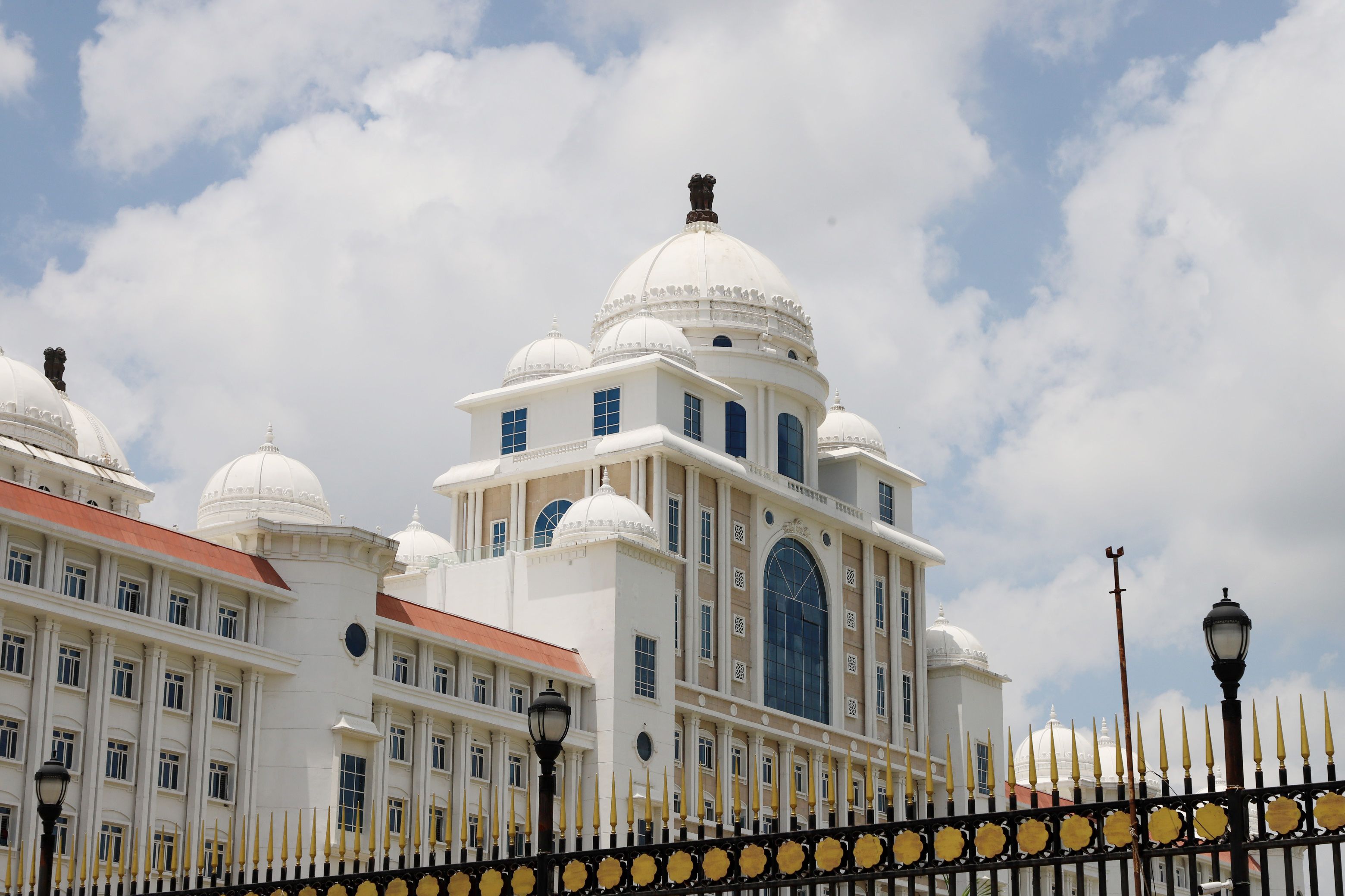 Stunning neoclassical architecture with domes and intricate details under a bright blue sky.