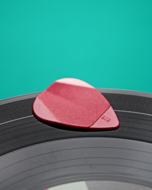 Shallow Focus Photo of Pink Guitar Pick