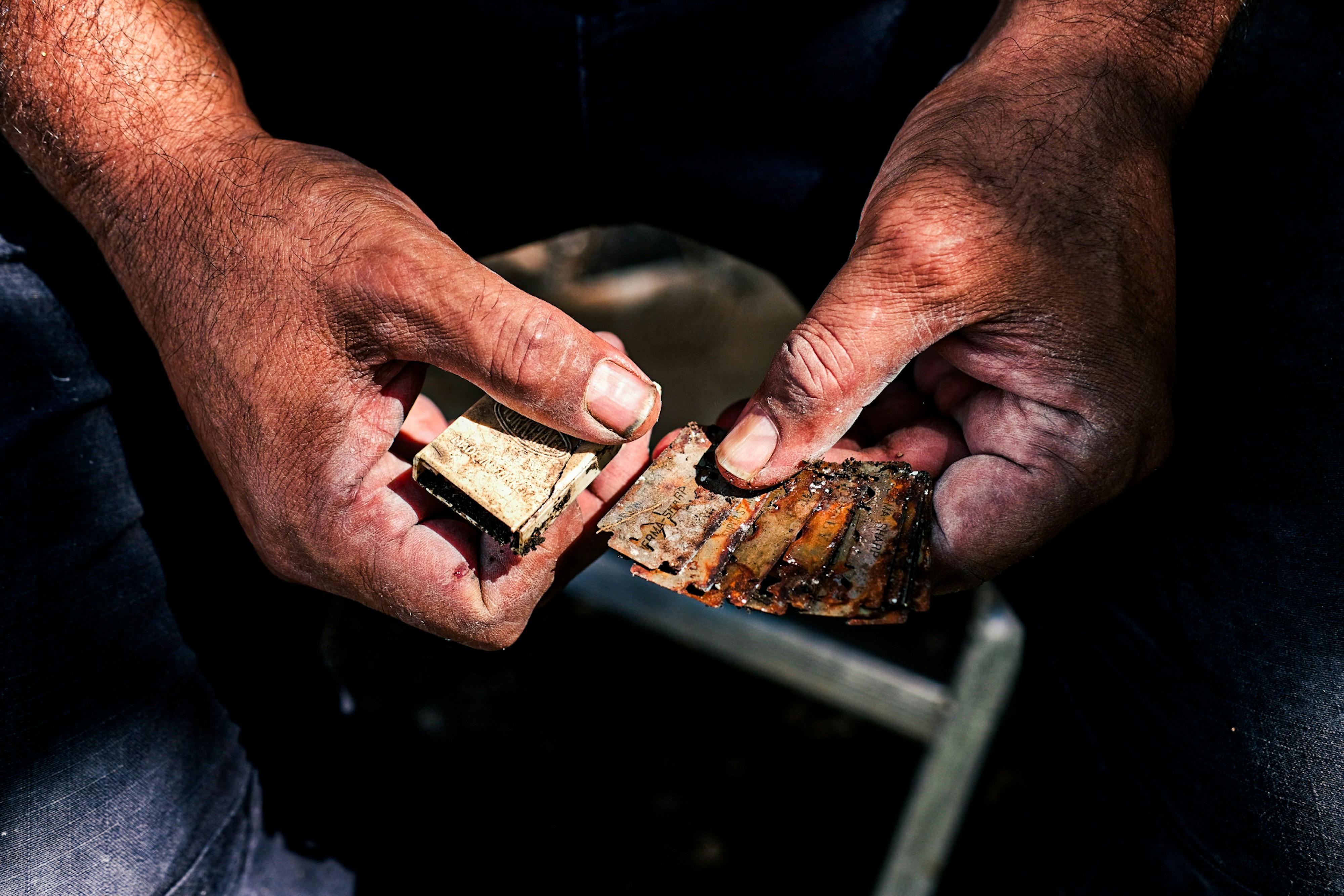 Close-up of a craftsman's hands holding rustic tools, displaying skilled artistry in Sütçüler, Türkiye.