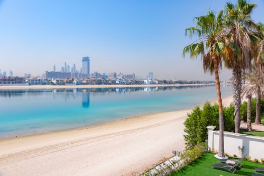 Stunning view of Dubai skyline from Palm Jumeirah featuring clear skies and turquoise waters.