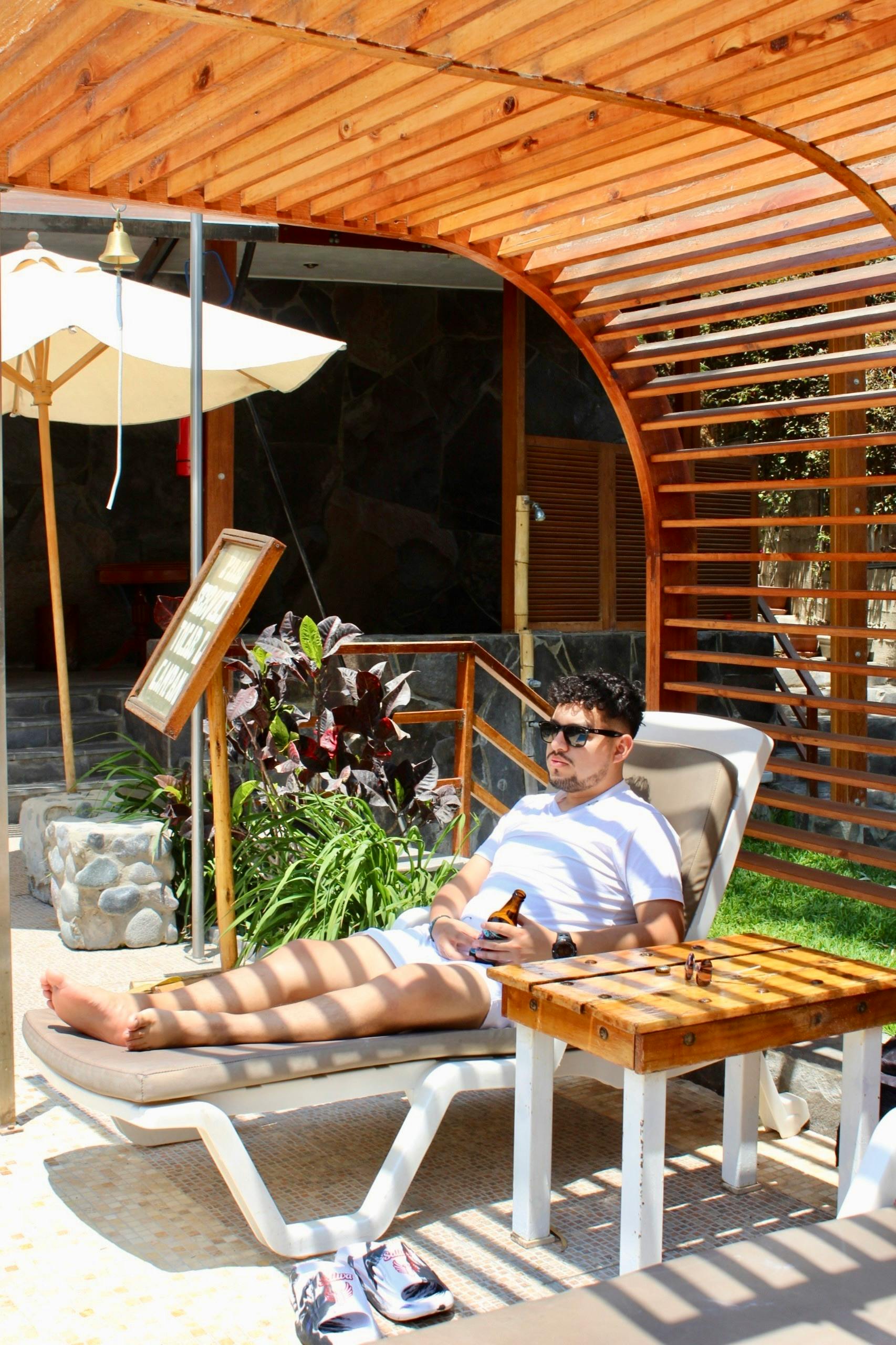Free Man enjoying a sunny day by the pool in Lunahuaná, Peru. Stock Photo