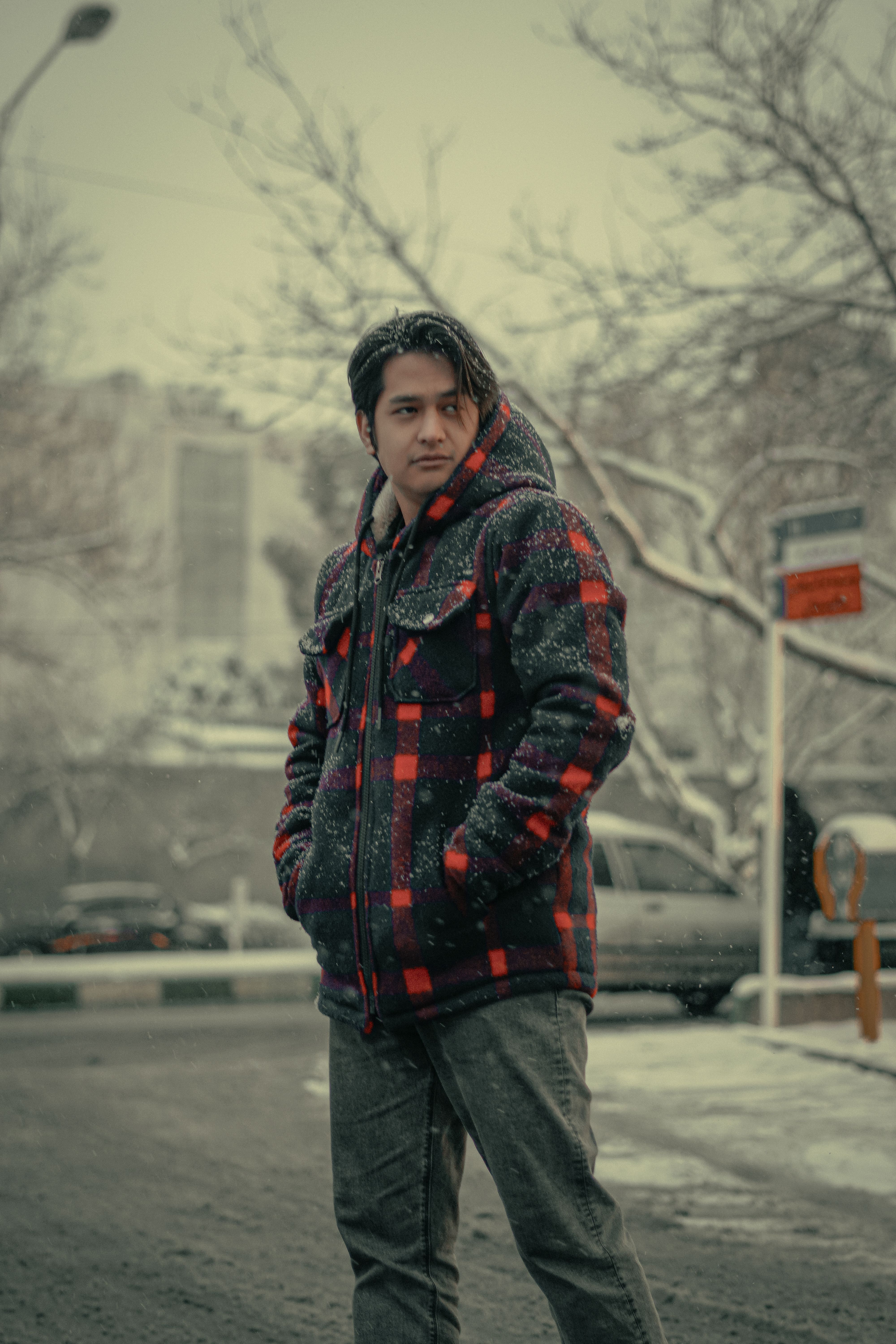 Young man in winter clothing on a snowy street · Free Stock Photo
