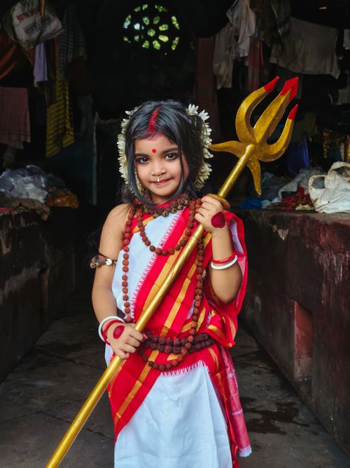 Free Charming young girl dressed as Goddess Durga with a trident, celebrating Durga Puja in Kolkata. Stock Photo