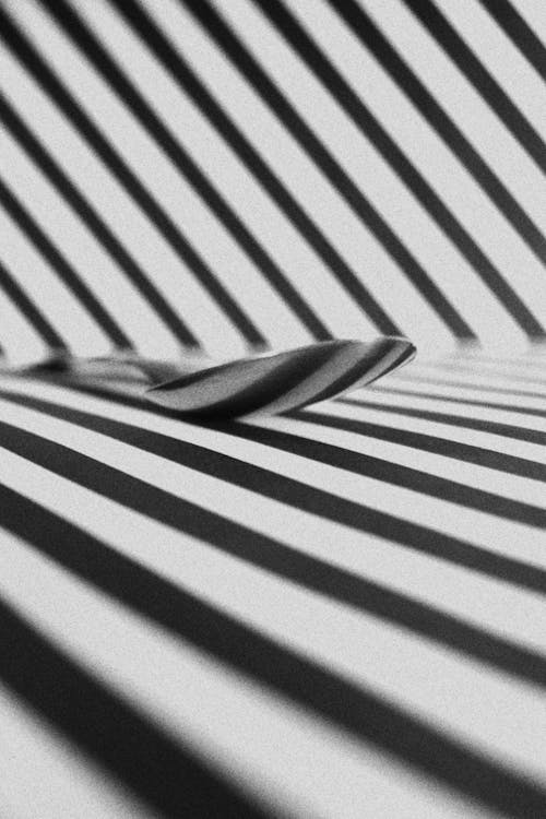 Spoon On A Surface With Black And White Stripes 